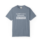 Gray t-shirt with humorous, funny, witty 'My Sleep Schedule is Sponsored by New Episodes' text design on a white background