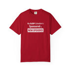 Red t-shirt with funny, witty 'My Sleep Schedule is Sponsored by New Episodes' text design on a white background