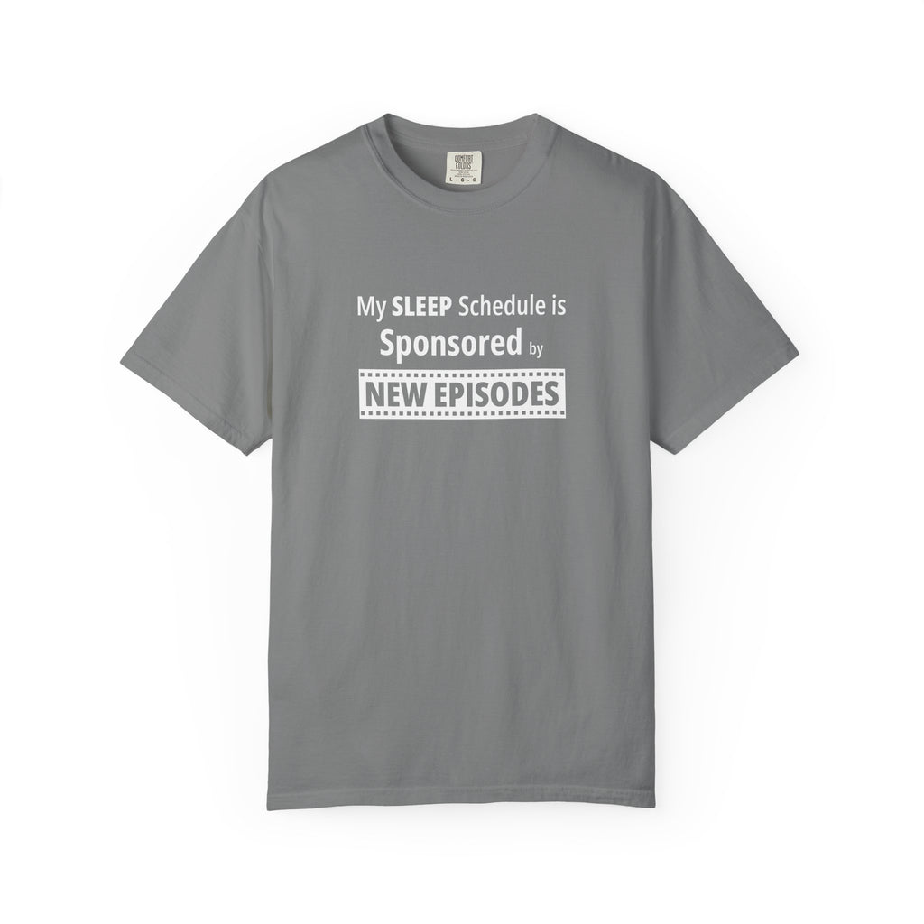 Gray t-shirt with humorous, funny, witty 'My Sleep Schedule is Sponsored by New Episodes' text design on a white background