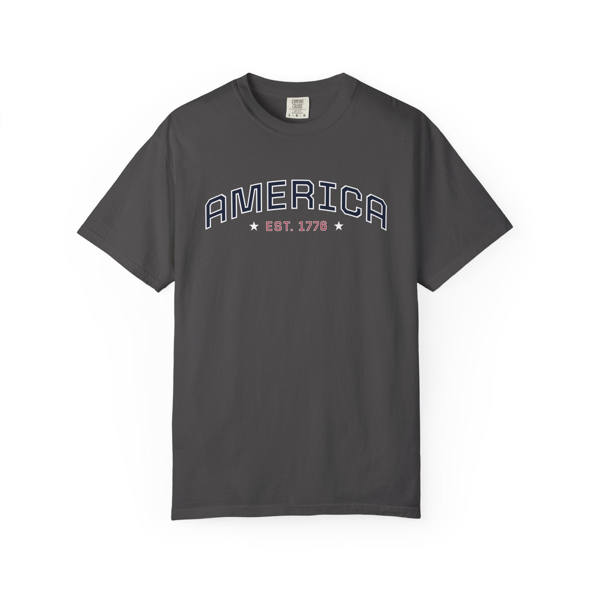Graphite t-shirt with 'AMERICA EST. 1776' typography design in varsity style on a white background
