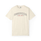 Ivory t-shirt with 'AMERICA EST. 1776' typography design in varsity style on a white background