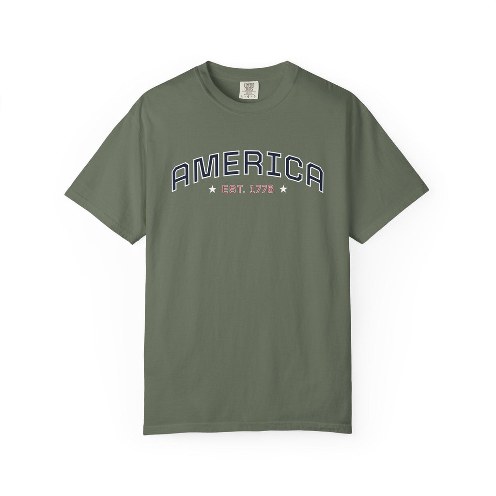 Moss t-shirt with 'AMERICA EST. 1776' typography design in varsity style on a white background