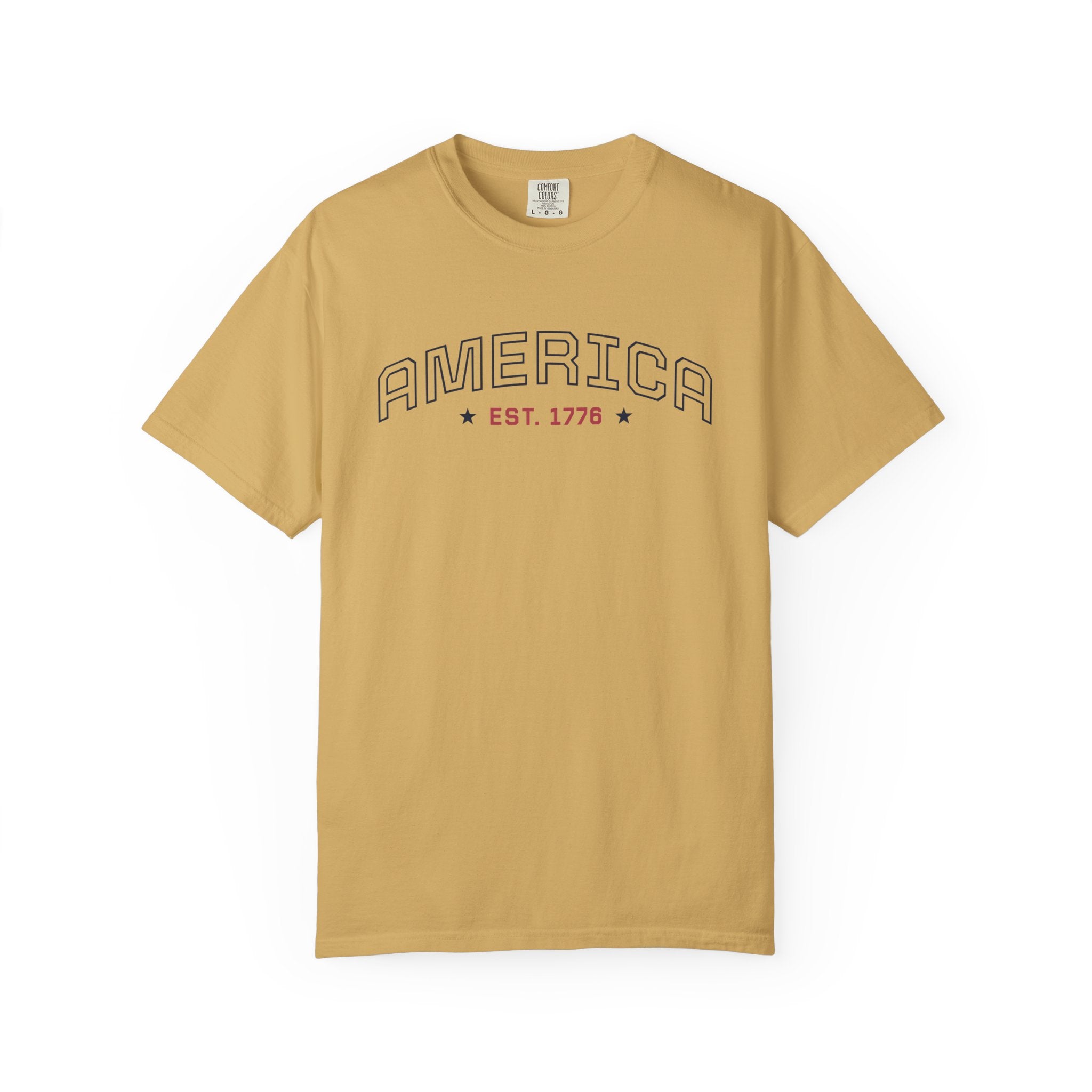 Mustard t-shirt with 'AMERICA EST. 1776' typography design in varsity style on a white background