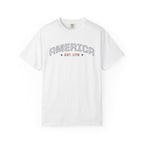 White t-shirt with 'AMERICA EST. 1776' typography design in varsity style on a white background