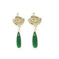 Gold earrings with green teardrop-shaped drops on a white background
