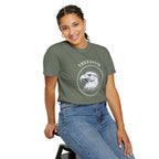 a woman wearing a grey t-shirt with the eagle freedom and starts graphic design on a white background.