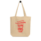 Beige tote bag with red text and graphic on a white background