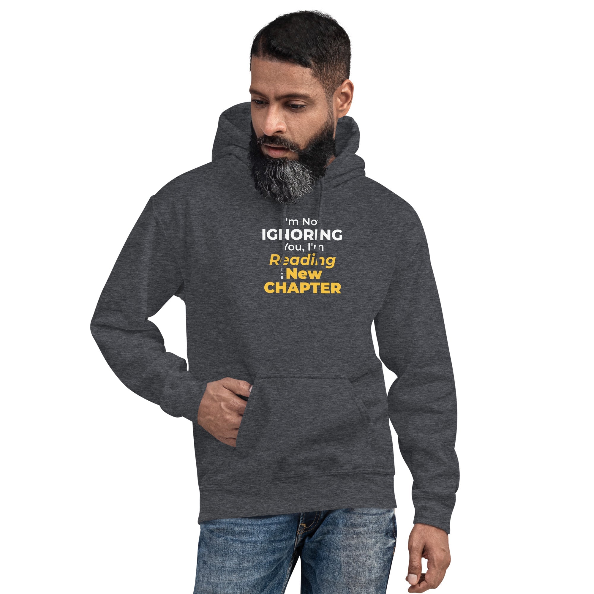 Man wearing a dark gray hoodie with 'I'm Not Ignoring You, I'm Reading the New Chapter' text on a white background