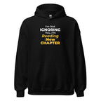 Black hoodie with a funny text 'I'm Not Ignoring You, I'm Reading a New Chapter' on a white background