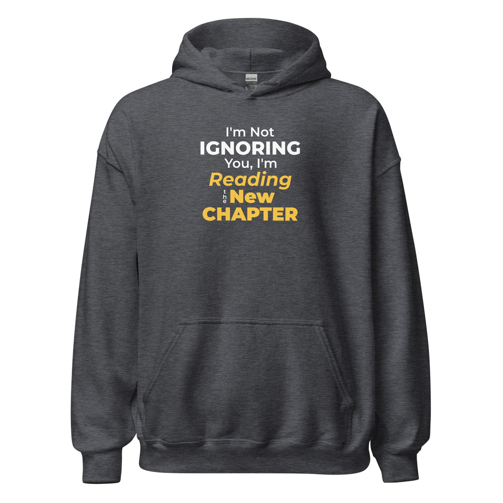Dark gray hoodie with humorous 'I'm Not Ignoring You, I'm Reading the New Chapter' text design on a white background