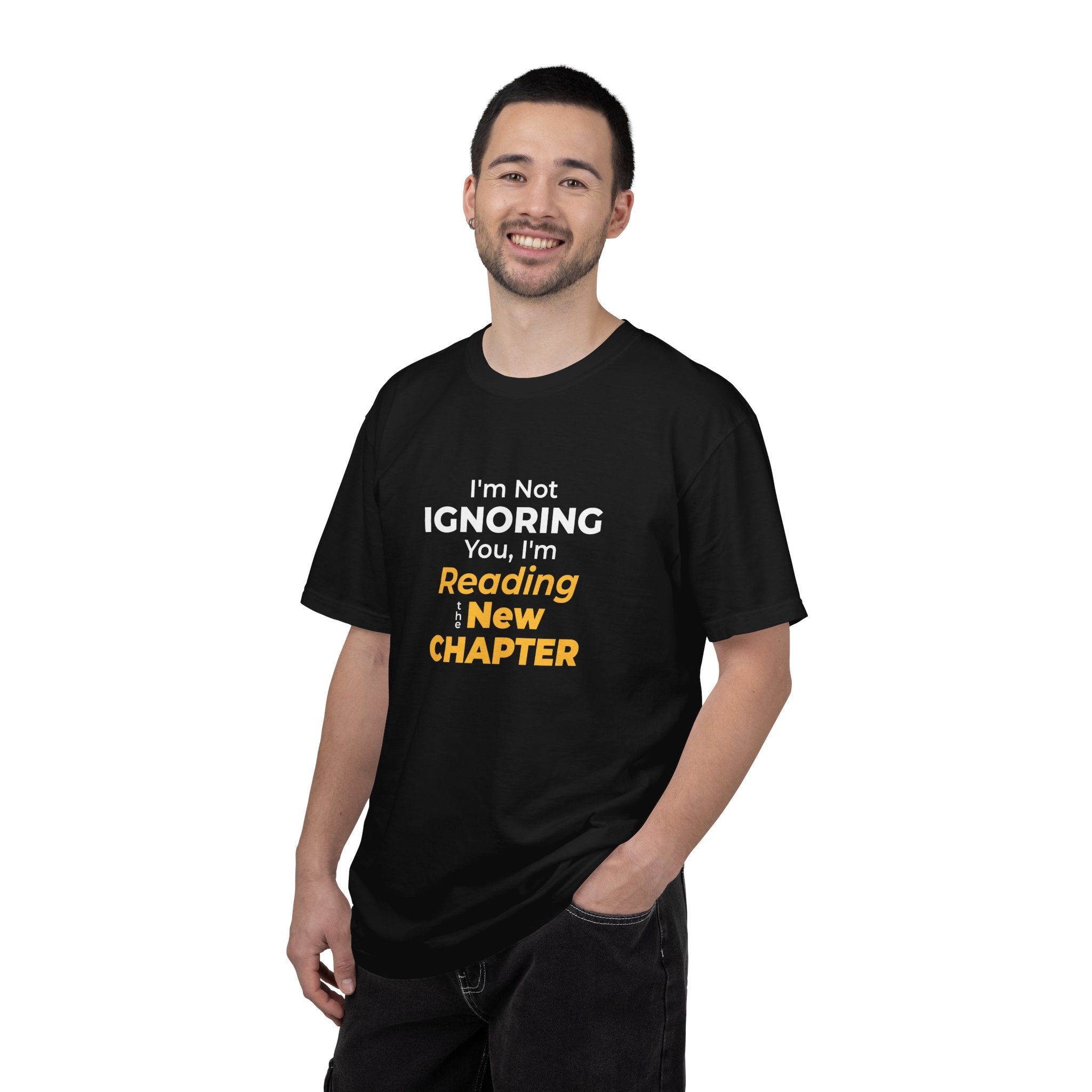 A men wearing Black t-shirt with text 'I'm Not Ignoring You, I'm Reading the New Chapter' on a white background