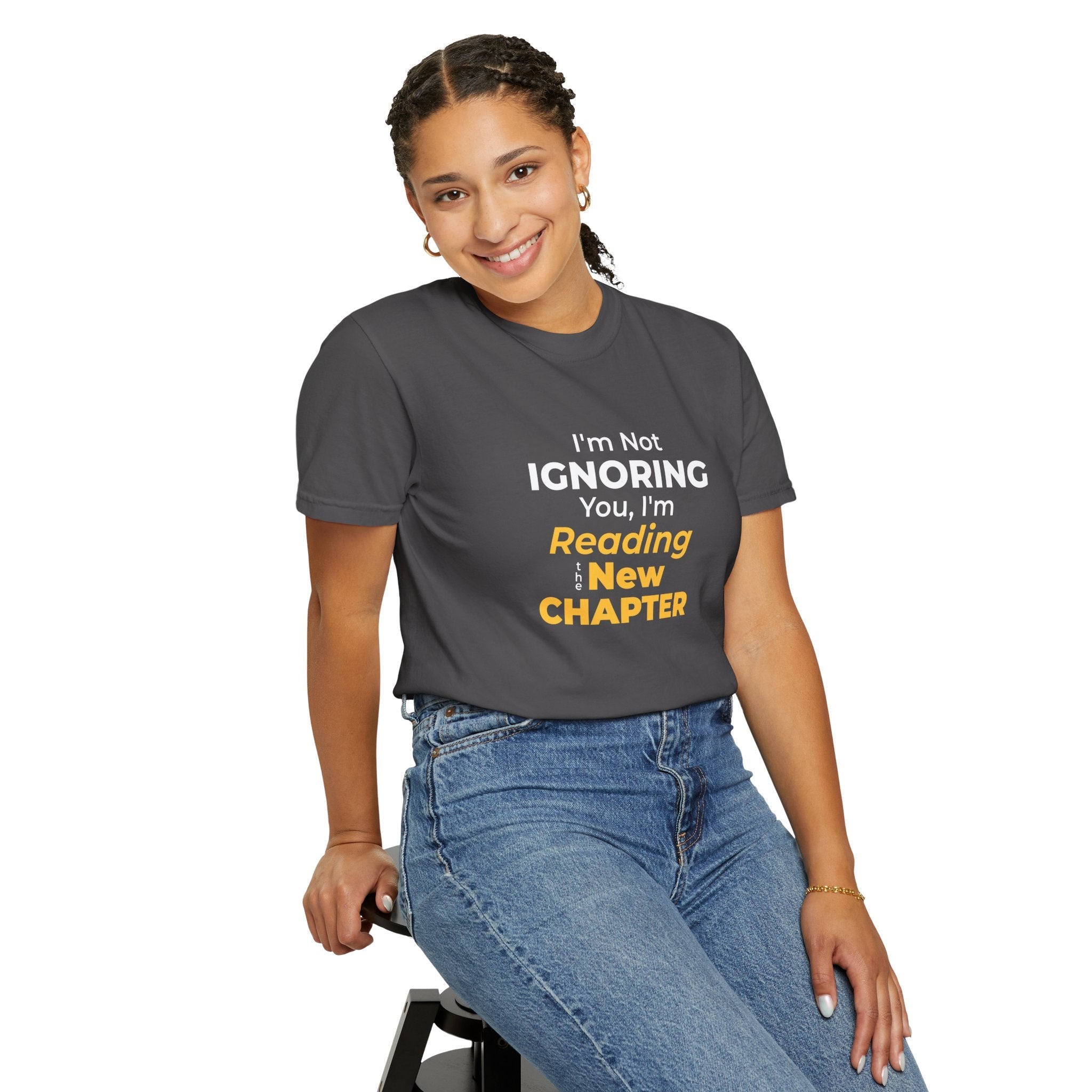 A women wearing Graphite t-shirt with text 'I'm Not Ignoring You, I'm Reading the New Chapter' on a white background