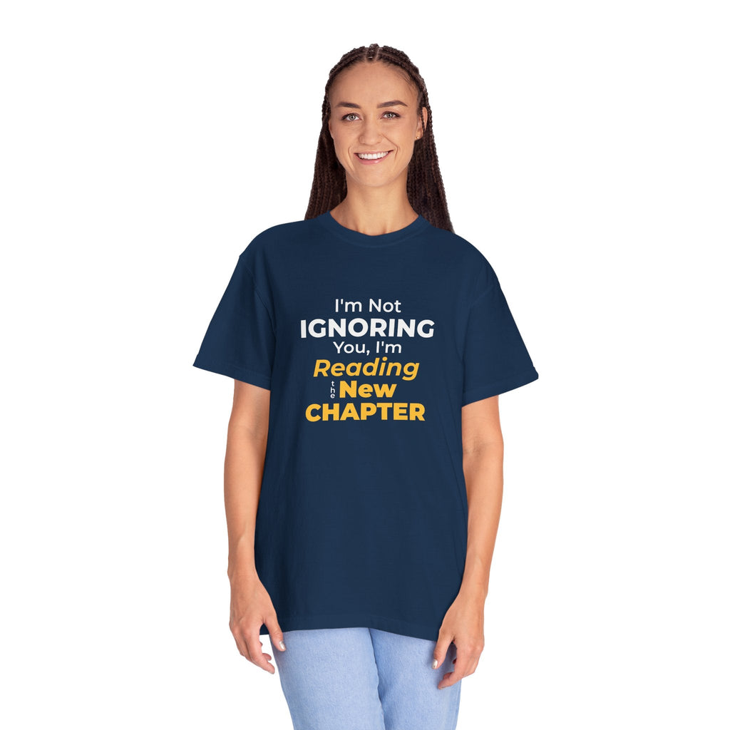 A women wearing NAvy t-shirt with text 'I'm Not Ignoring You, I'm Reading the New Chapter' on a white background
