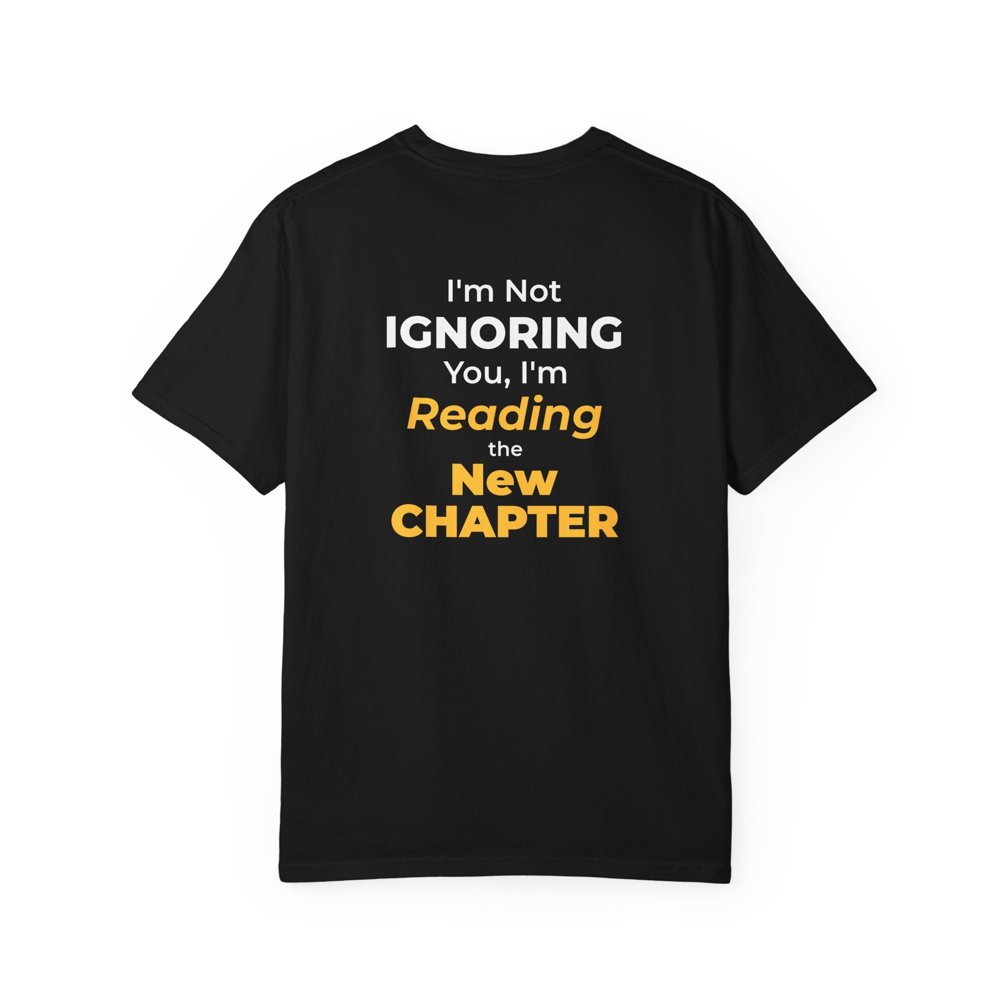 Black t-shirt with text 'I'm Not Ignoring You, I'm Reading the New Chapter' on the back side on a white background