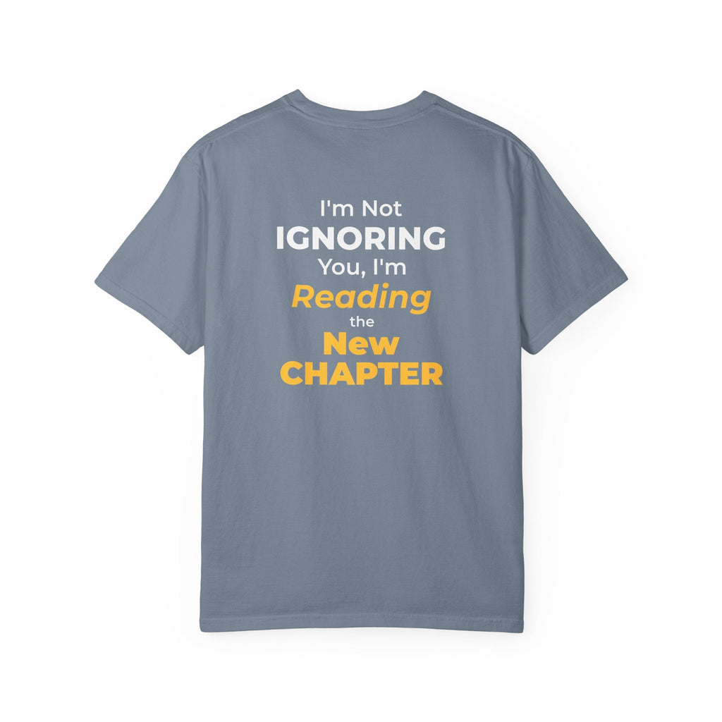 Blue Jean t-shirt with text 'I'm Not Ignoring You, I'm Reading the New Chapter' on the back side on a white background