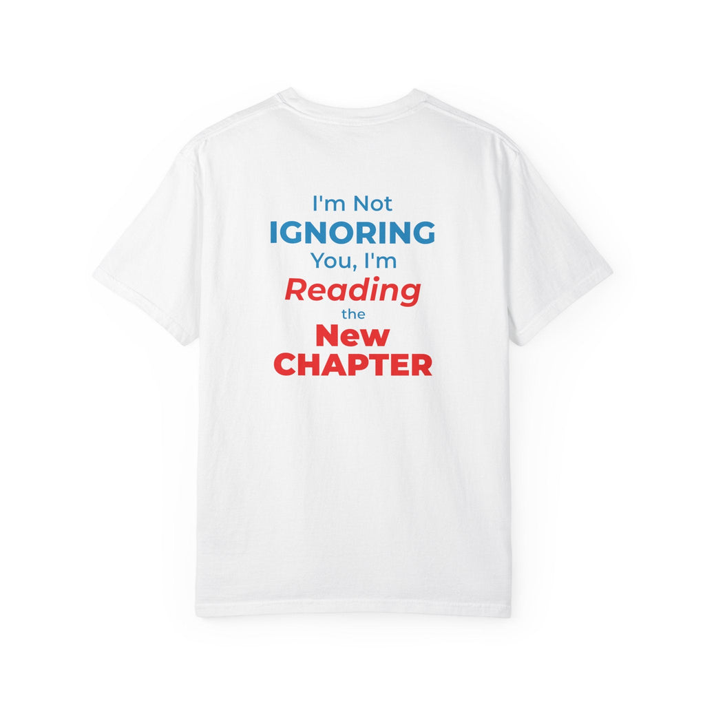 White t-shirt with text 'I'm Not Ignoring You, I'm Reading the New Chapter' on the back side on a white background