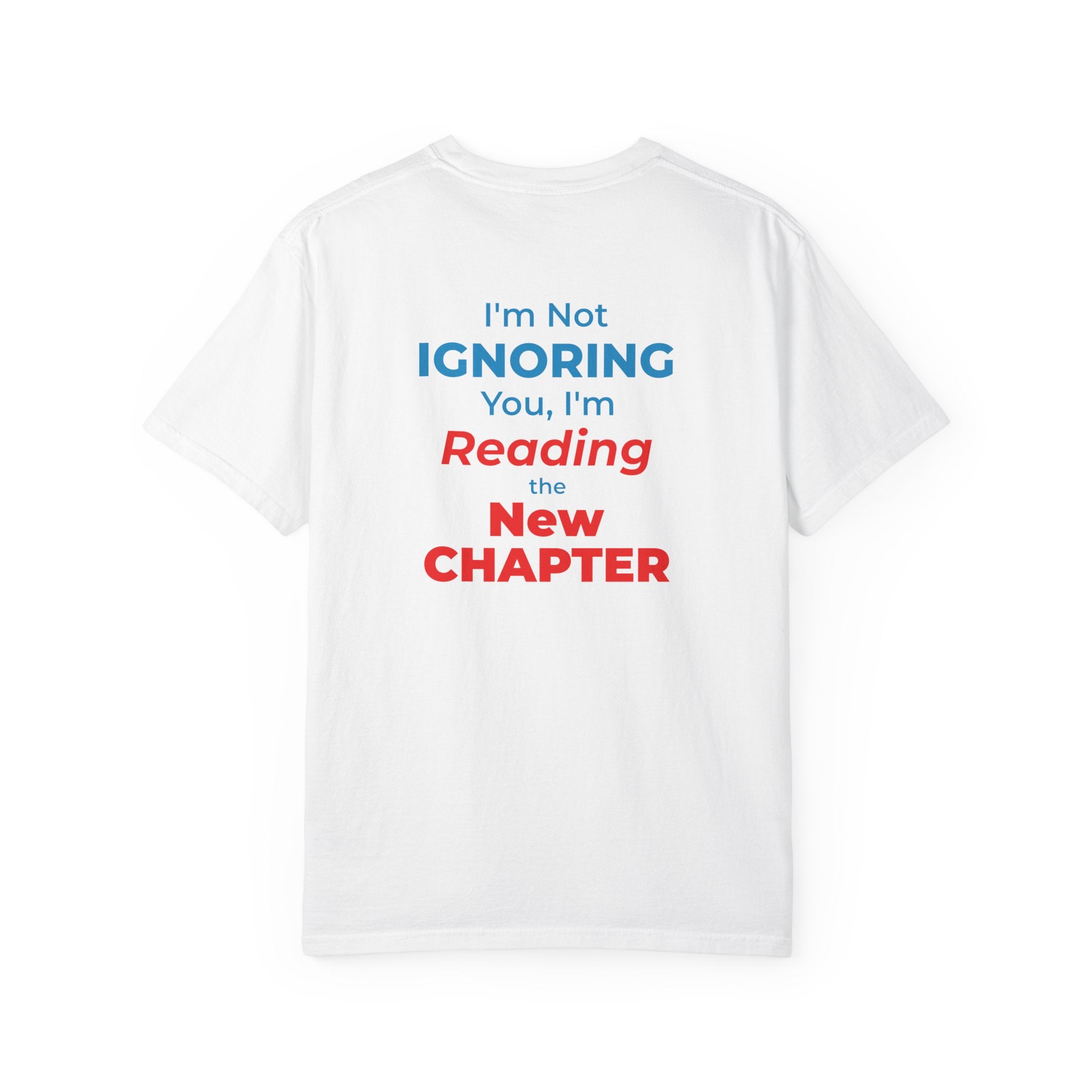 White t-shirt with text 'I'm Not Ignoring You, I'm Reading the New Chapter' on the back side on a white background
