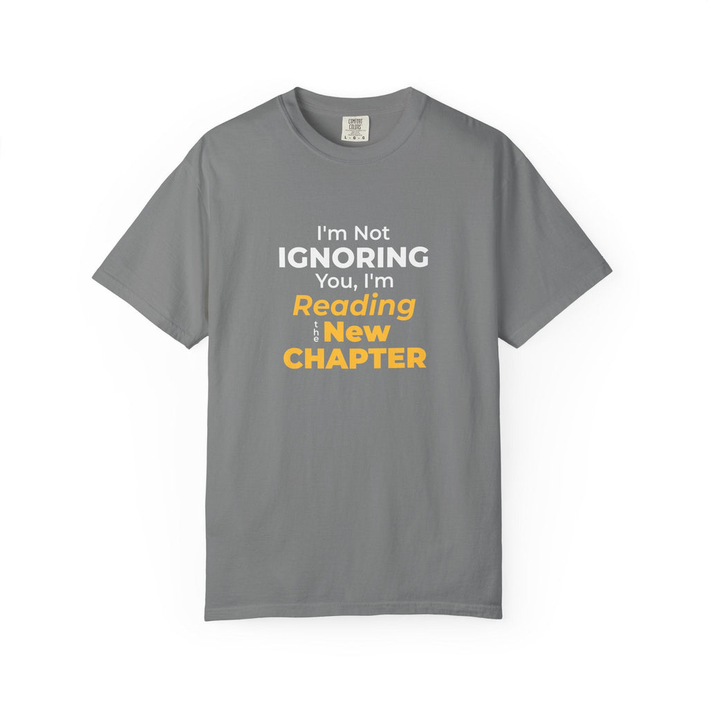Grey t-shirt with text 'I'm Not Ignoring You, I'm Reading the New Chapter' on a white background