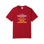 Red t-shirt with text 'I'm Not Ignoring You, I'm Reading the New Chapter' on a white background