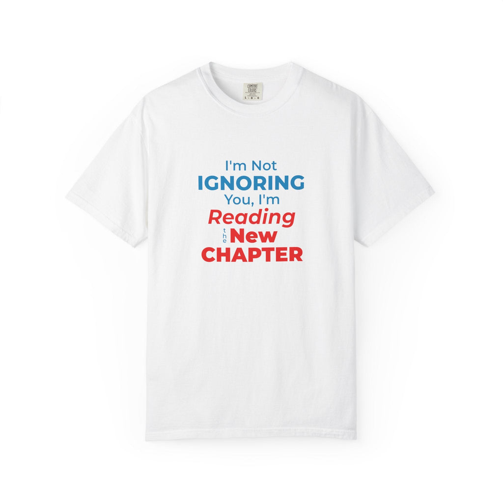 White t-shirt with text 'I'm Not Ignoring You, I'm Reading the New Chapter' on a white background