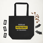 Black tote bag with 'Isekai Protagonist in Training' text, surrounded by Halloween-themed items on a white background.