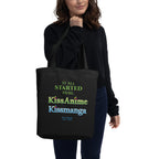 a woman holding a beige reusable tote bag with a tribute text and kissanime kissmanga logos design on a white background