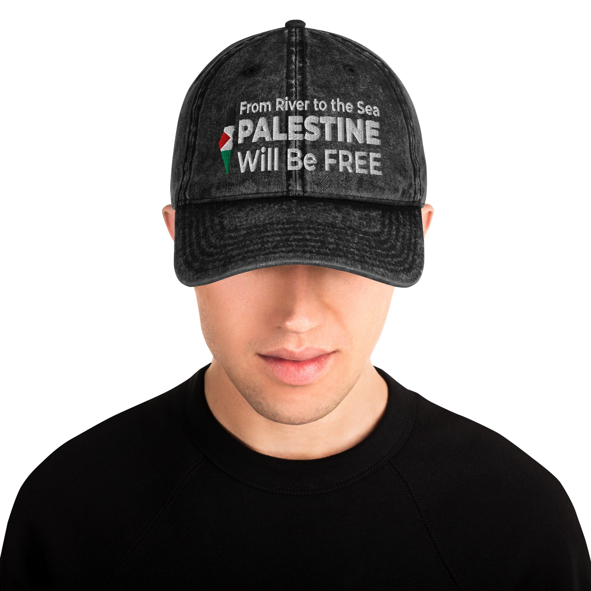 Person wearing a black cap with text and a Palestine flag design on a white background