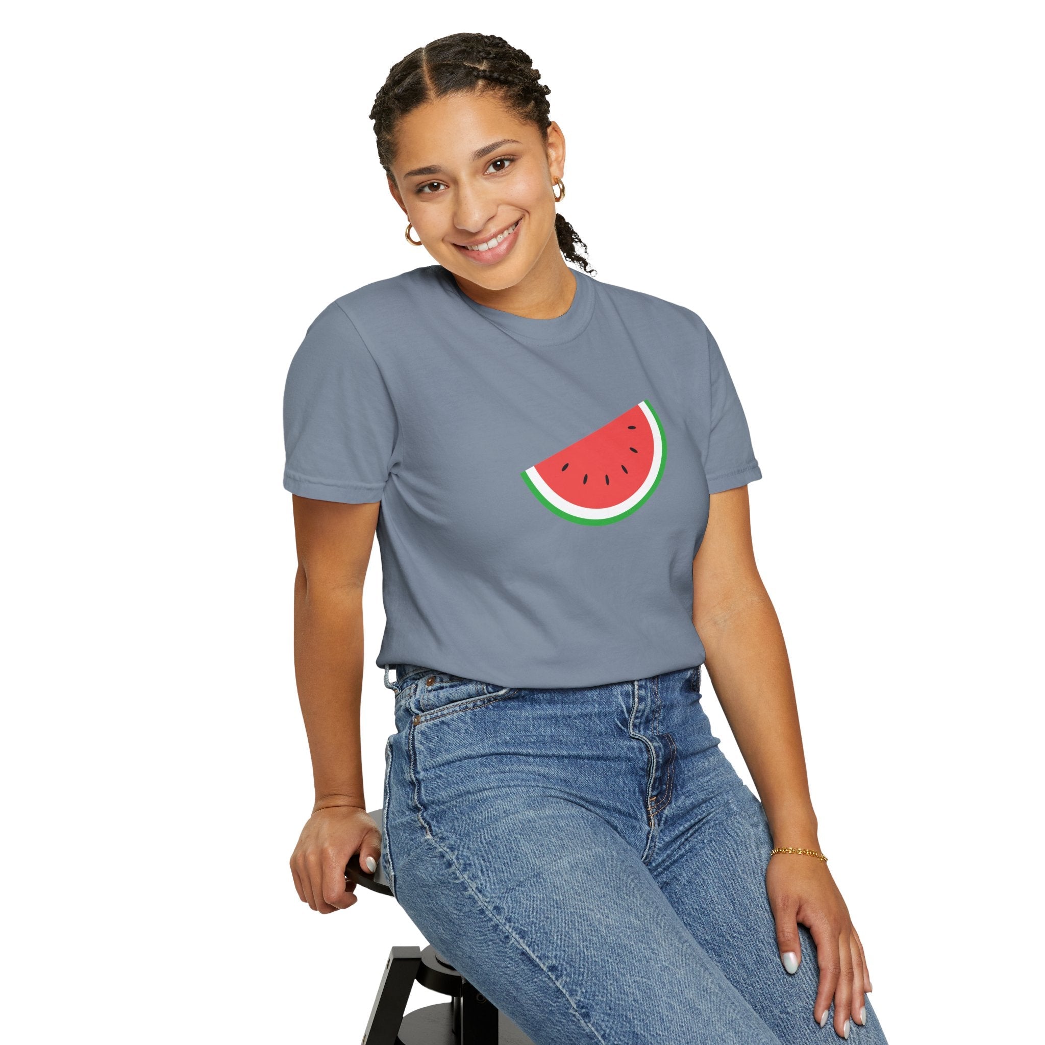 Person wearing a gray t-shirt with a watermelon design on a white background