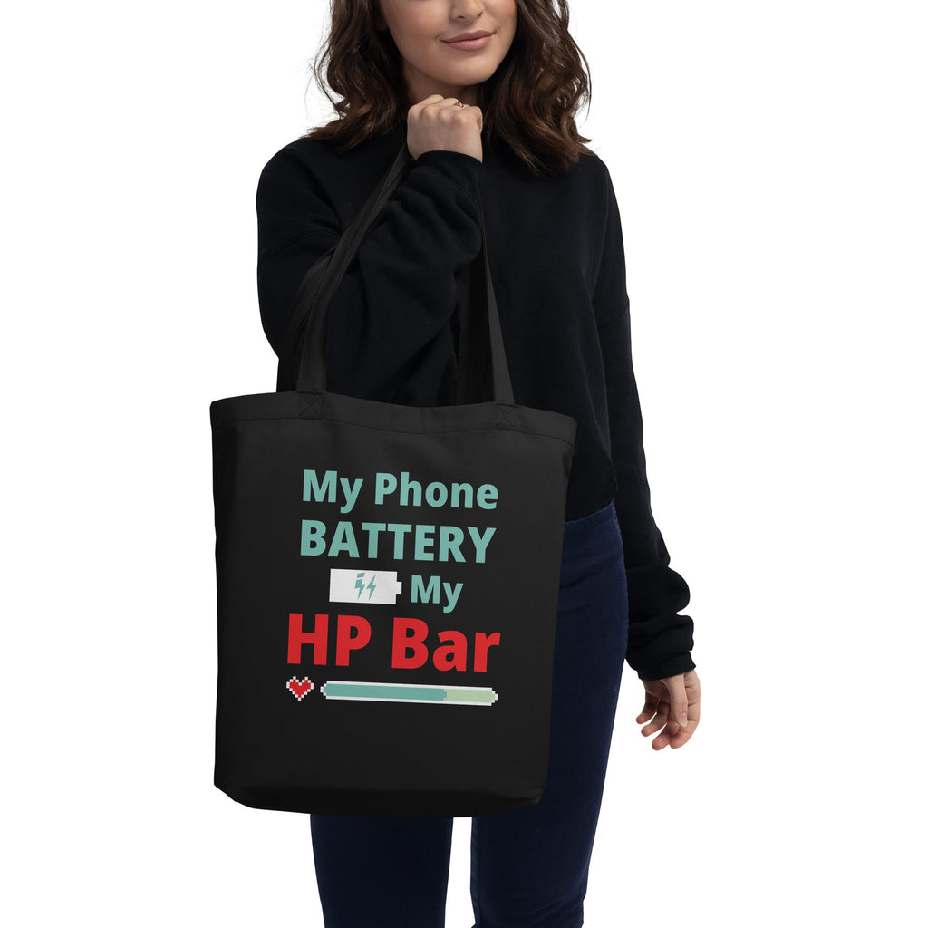 Person holding a black tote bag with humorous text design on a white background