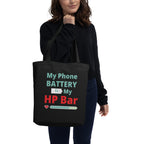 Person holding a black tote bag with humorous text design on a white background