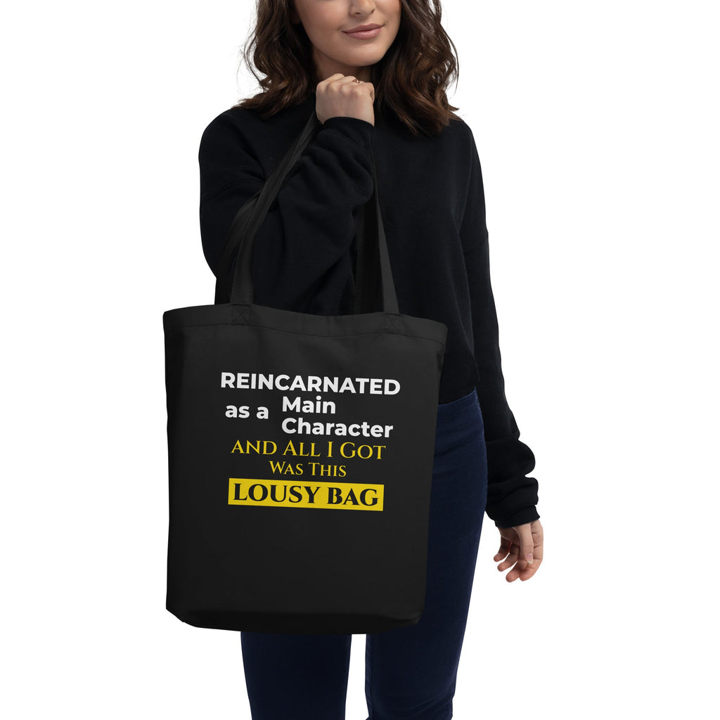 Person holding a black tote bag with humorous text design.