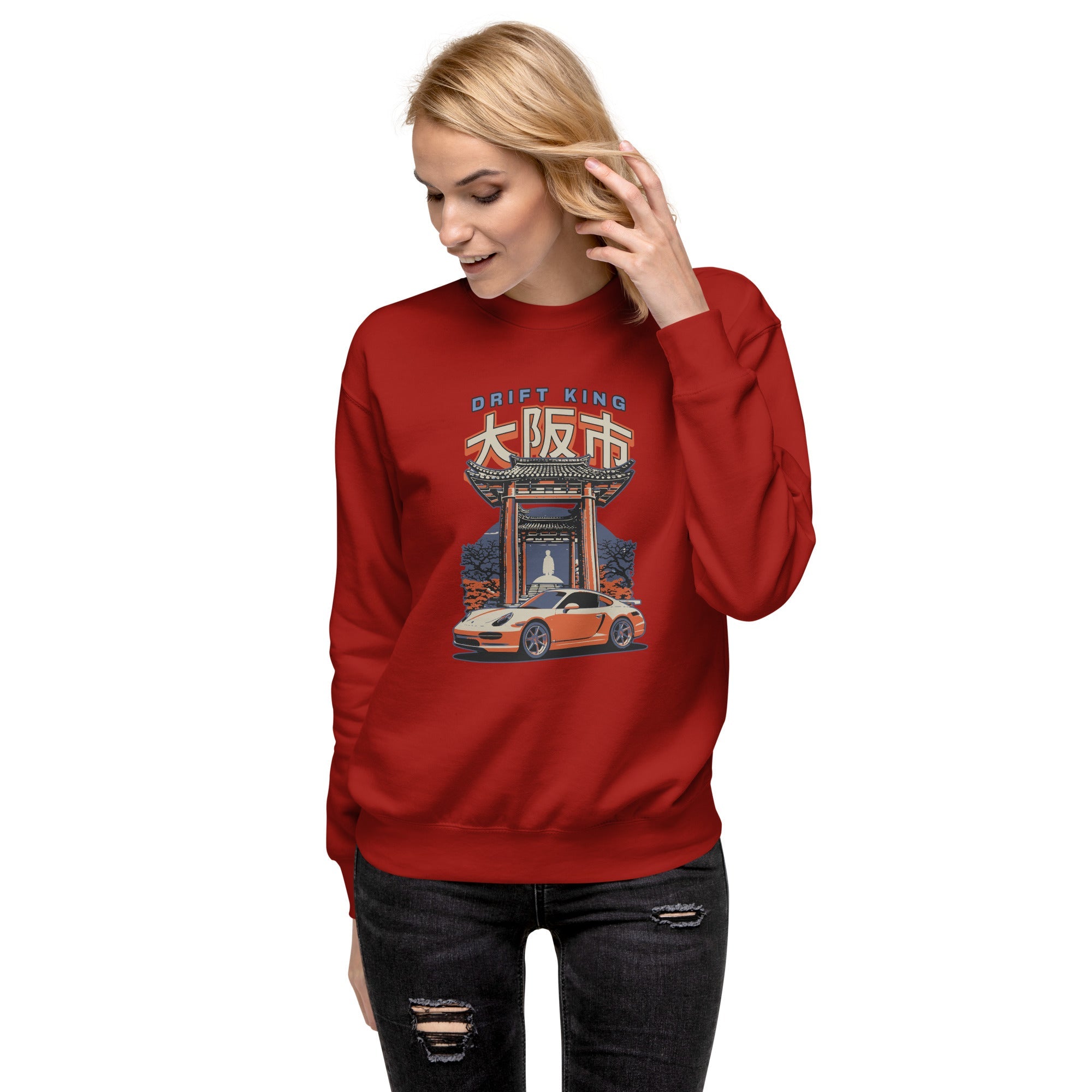 a woman wearing a cardinal red sweatshirt with a Drift King Japanese Porsche Car Graphic design against a white background