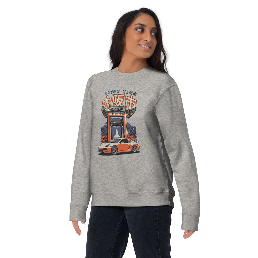 a woman wearing a sport grey sweatshirt with a Drift King Japanese Porsche Car Graphic design against a white background