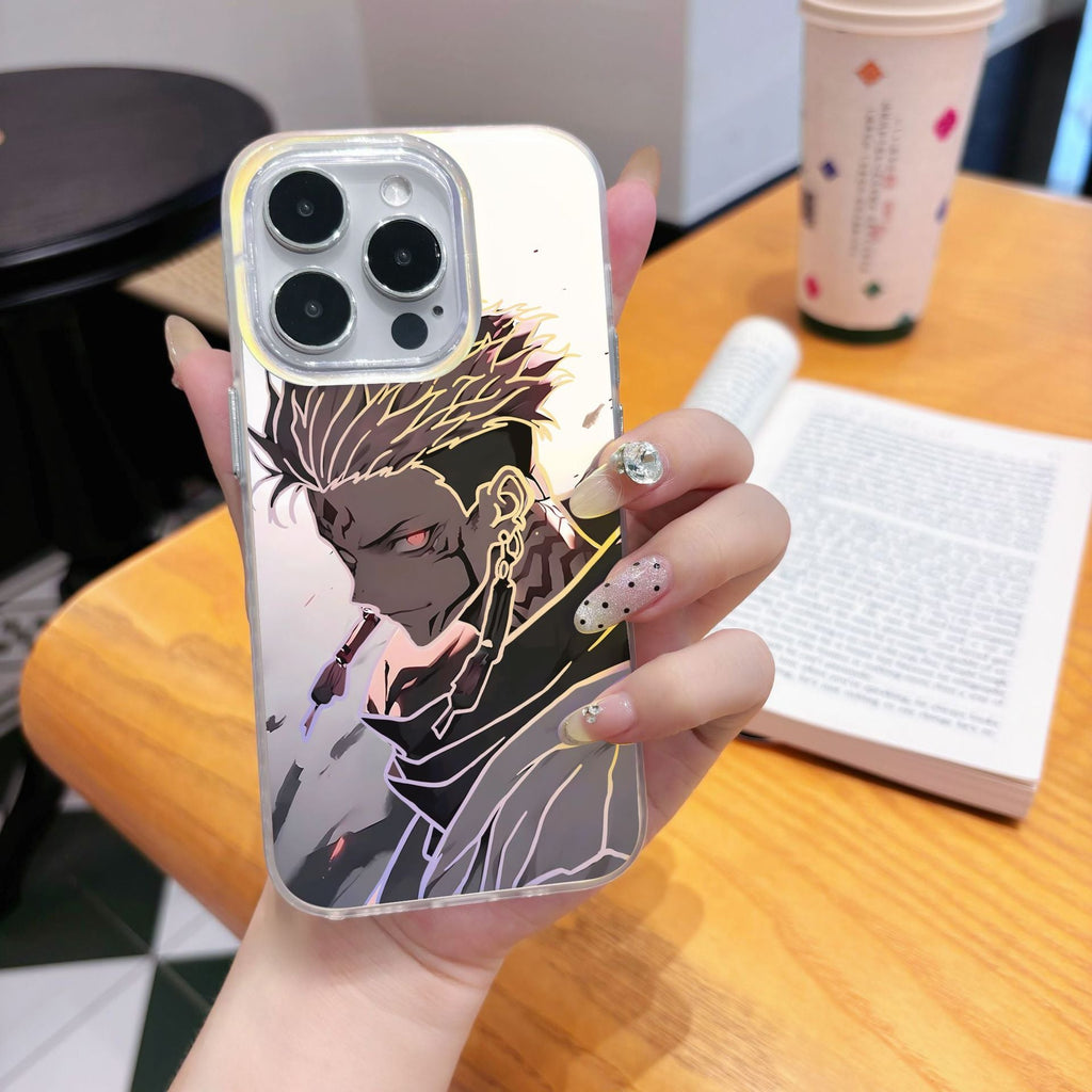 Phone case with an anime Jujutsu Kaisen Ryoma character design held by a person, with a blurred background of a table and book.