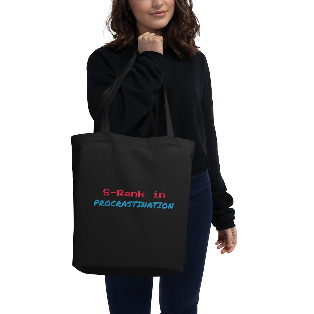 Person holding a black tote bag with text on a white background
