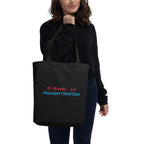 Person holding a black tote bag with text on a white background