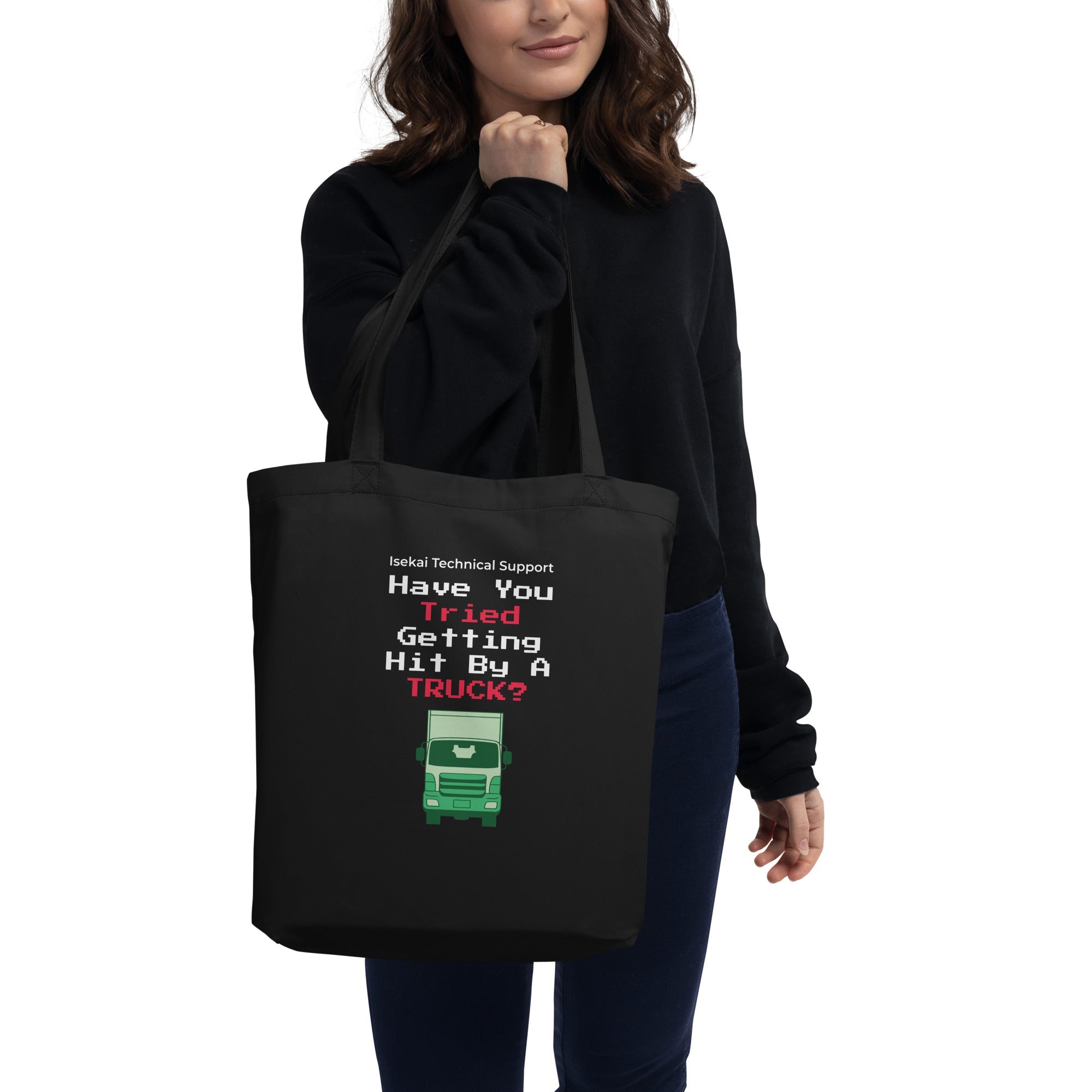 Person holding a black tote bag with humorous text design.