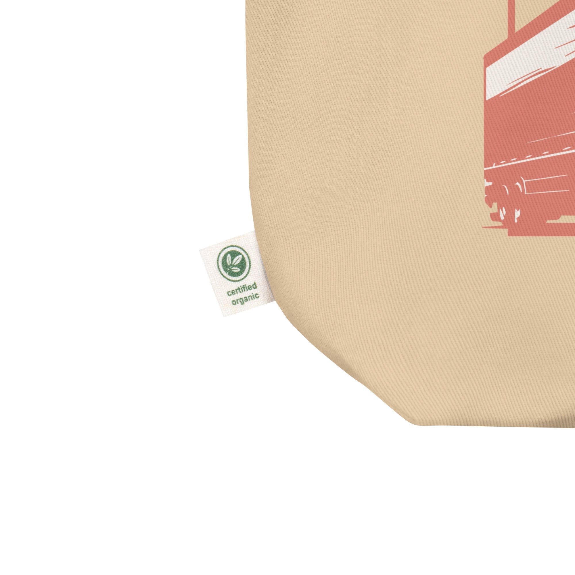 Beige tote bag with a red graphic and a green certification label on a white background