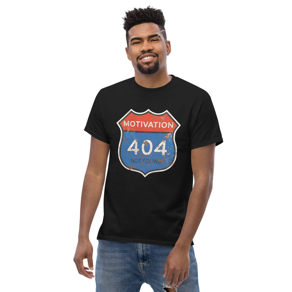 Man wearing a black t-shirt with a 'Motivation 404 Not Found' graphic design on a white background
