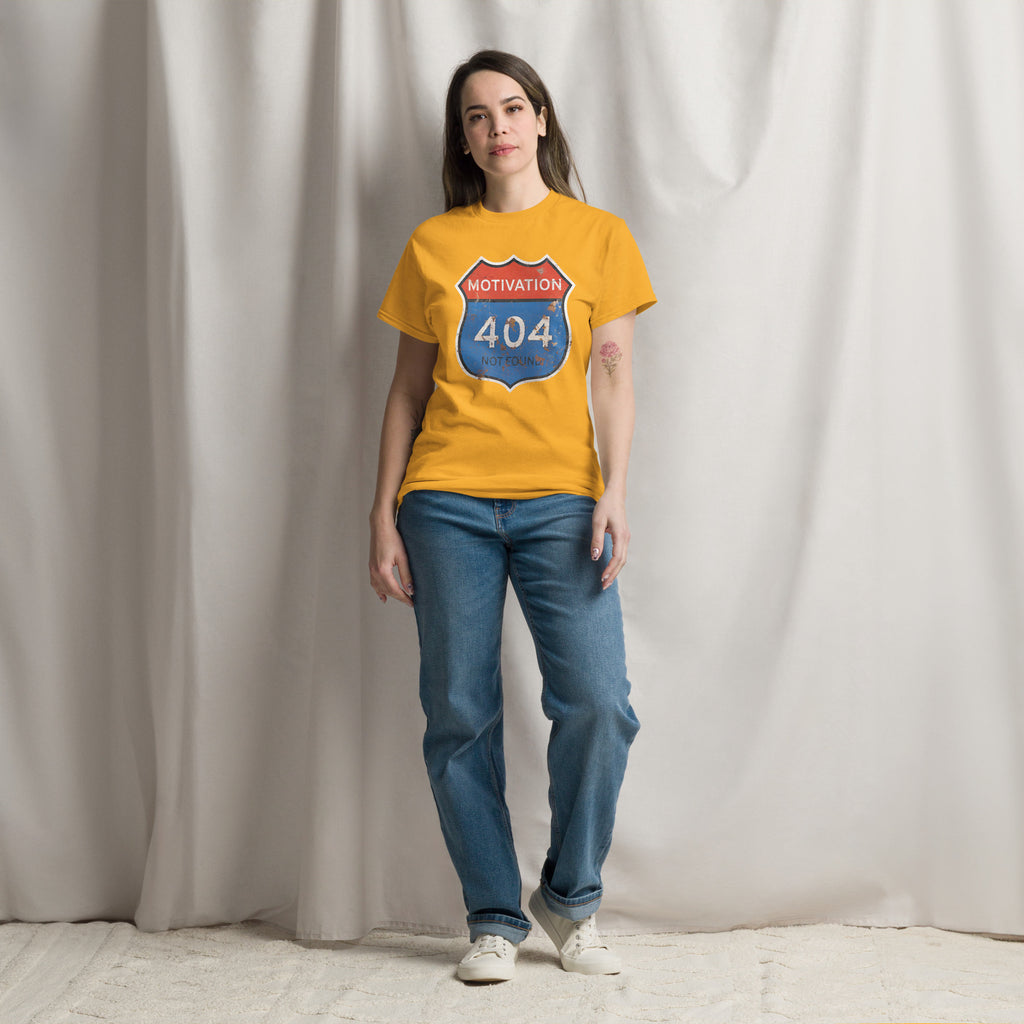 Person wearing a yellow t-shirt with a 'Motivation 404 Not Found' design against a plain background