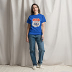 Person wearing a blue t-shirt with a graphic design against a plain background