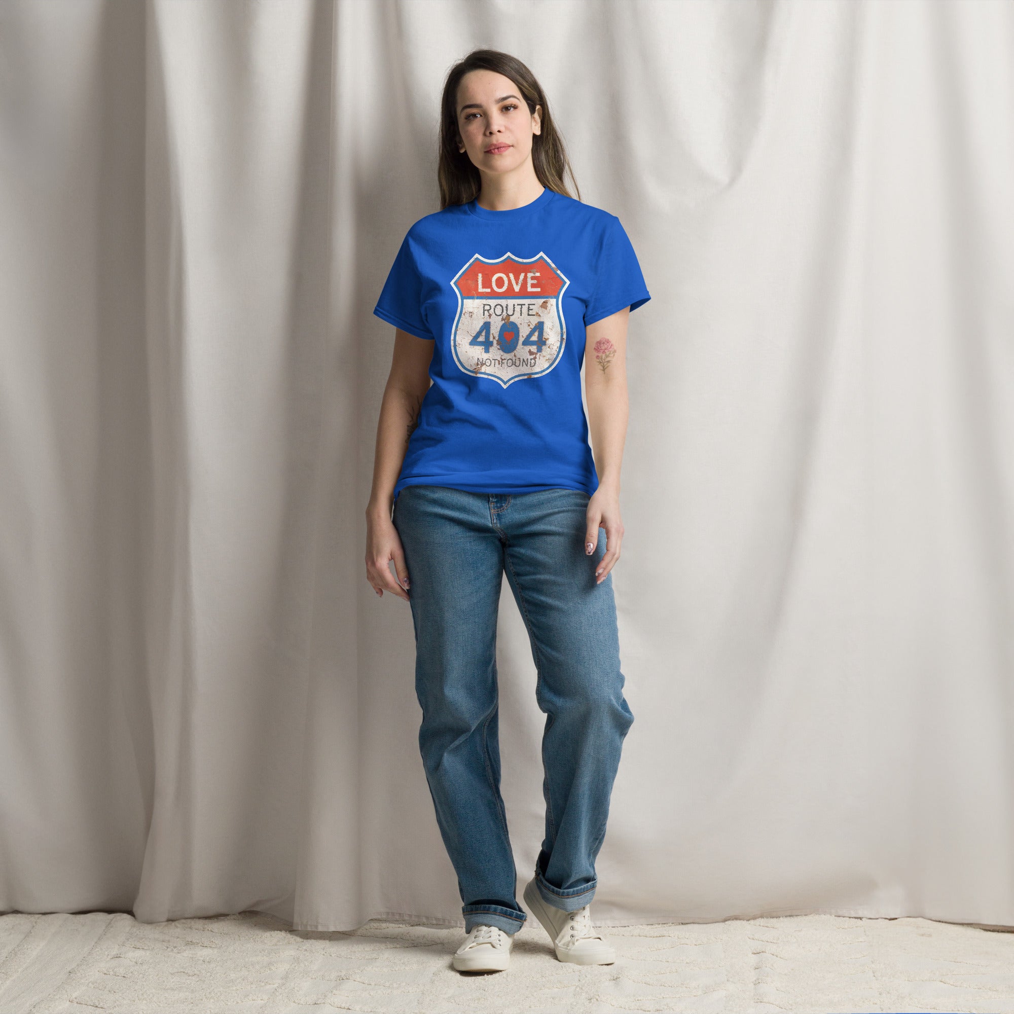 Person wearing a blue t-shirt with a graphic design against a plain background