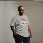 Man wearing a gray t-shirt with a graphic design on a plain background
