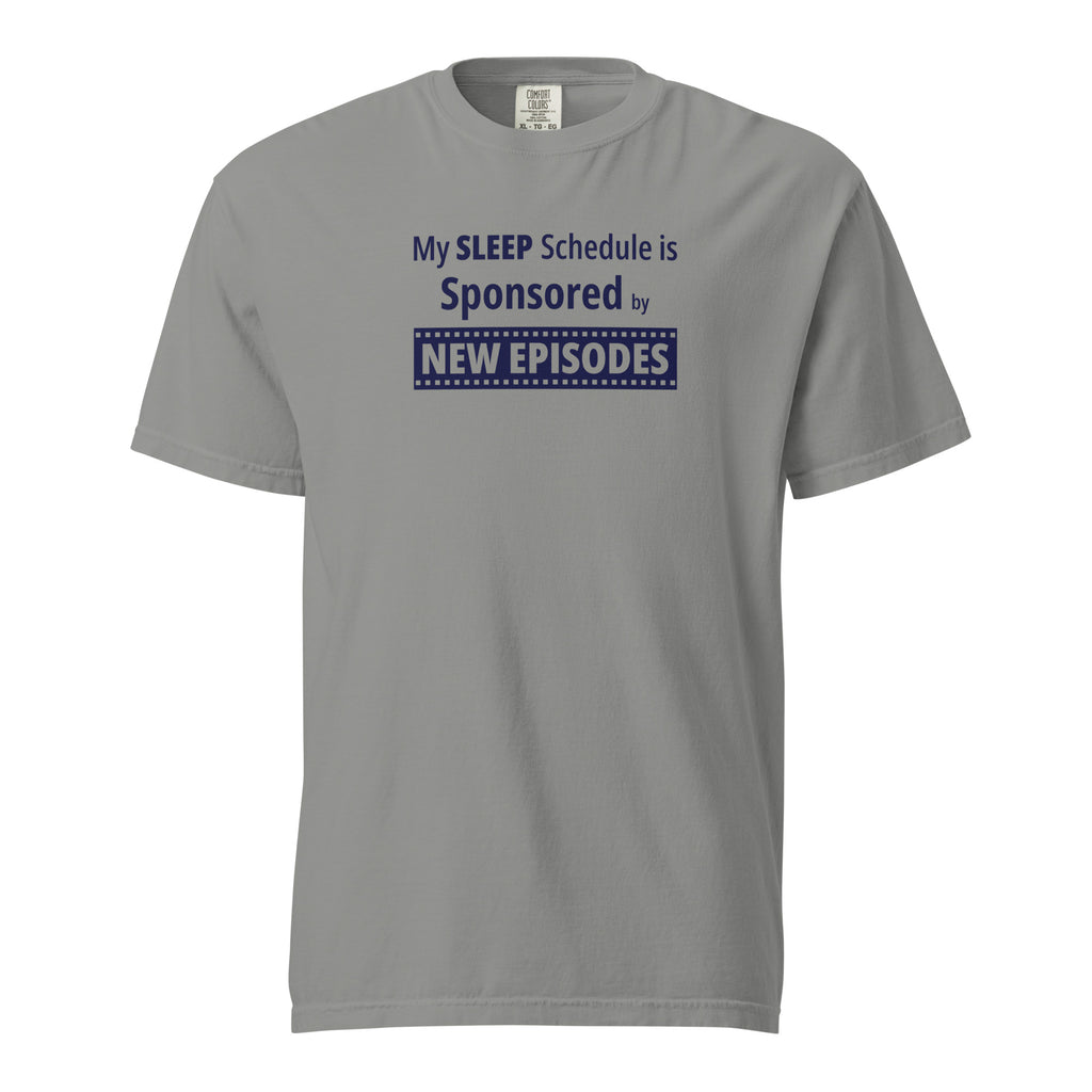 Gray t-shirt with humorous funny, witty 'My Sleep Schedule is Sponsored by New Episodes' text design on a white background