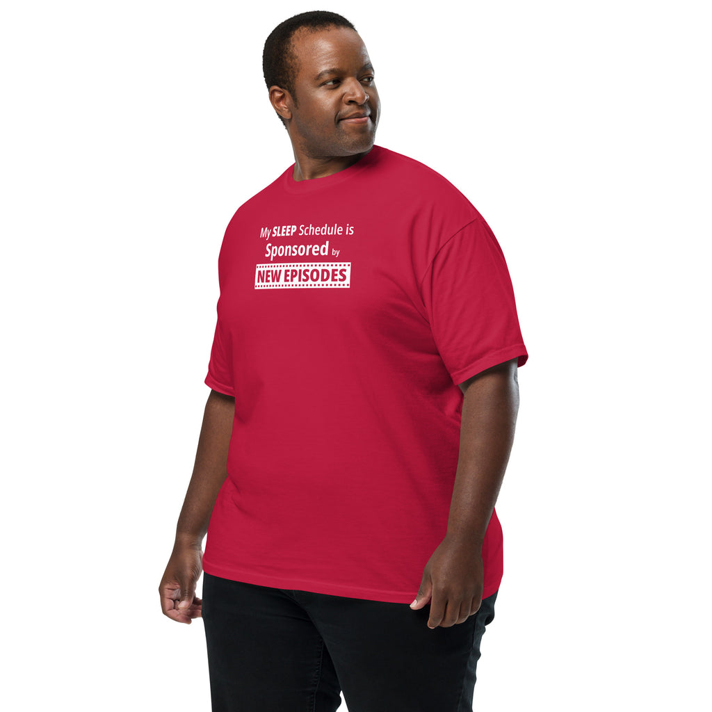 Man wearing a red t-shirt with humorous, funny, witty 'My Sleep Schedule is Sponsored by New Episodes' text design on a white background