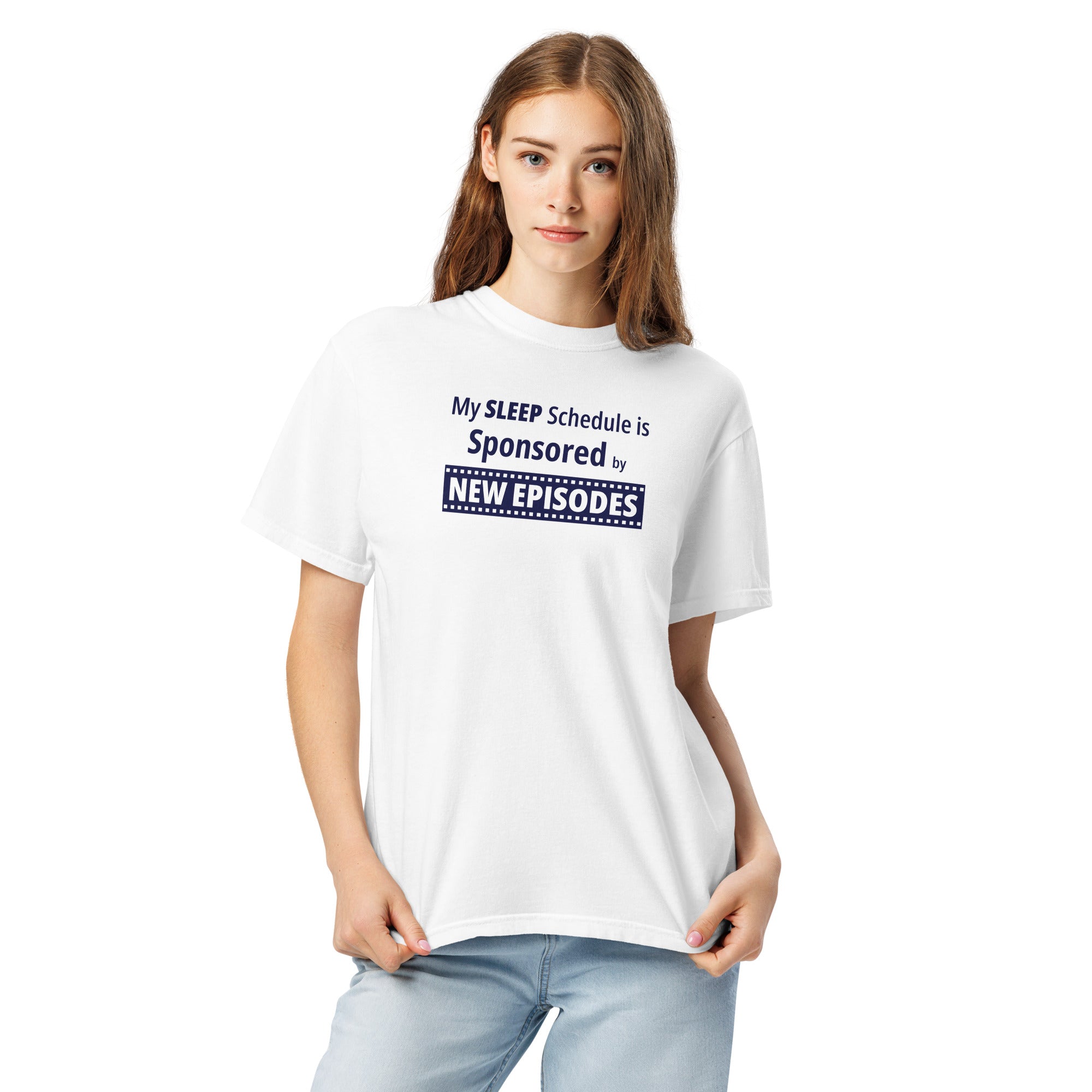 Person wearing a white t-shirt with funny, witty 'My Sleep Schedule is Sponsored by New Episodes' text design on a white background