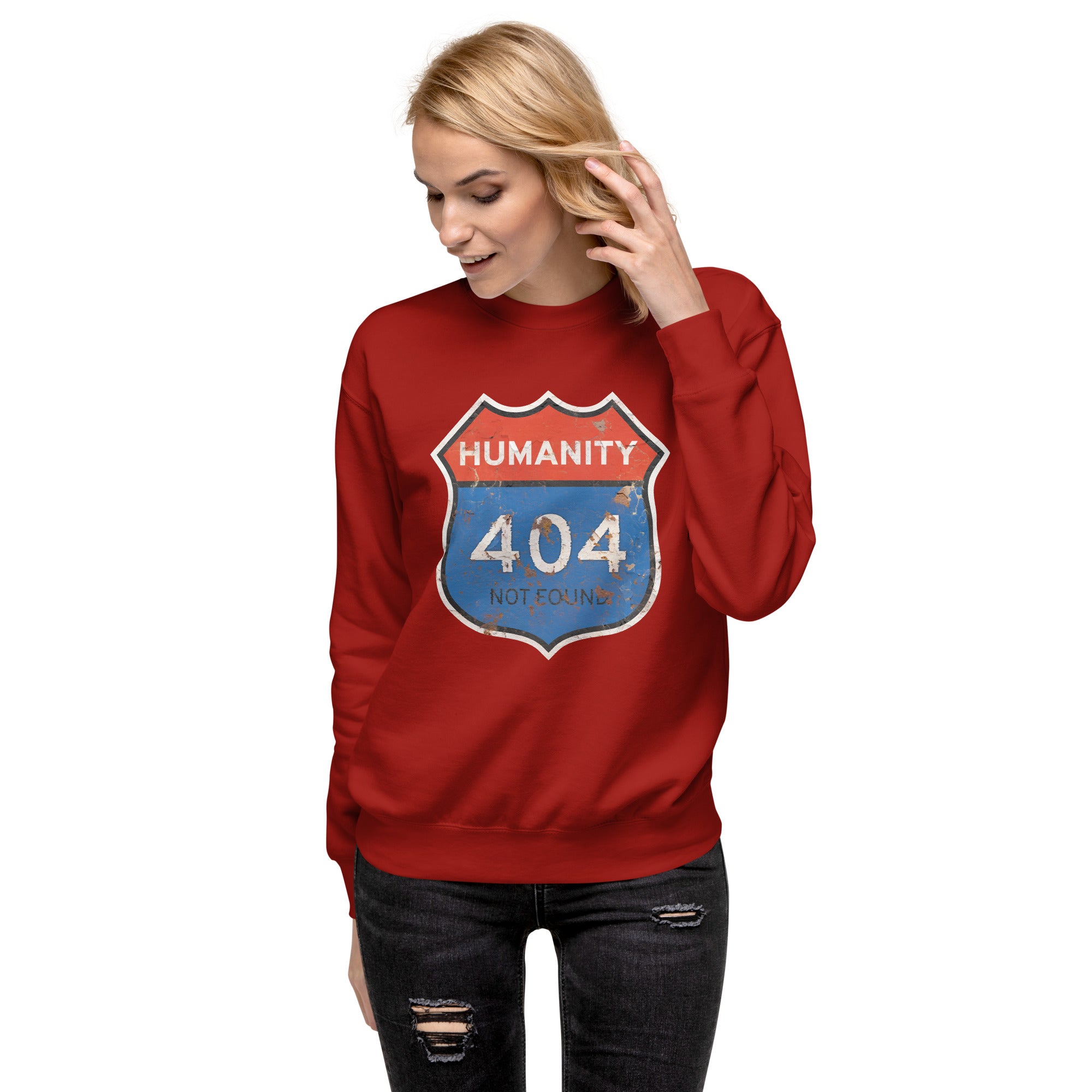 Person wearing a red sweatshirt with a 'Humanity 404 Not Found' graphic design on a white background