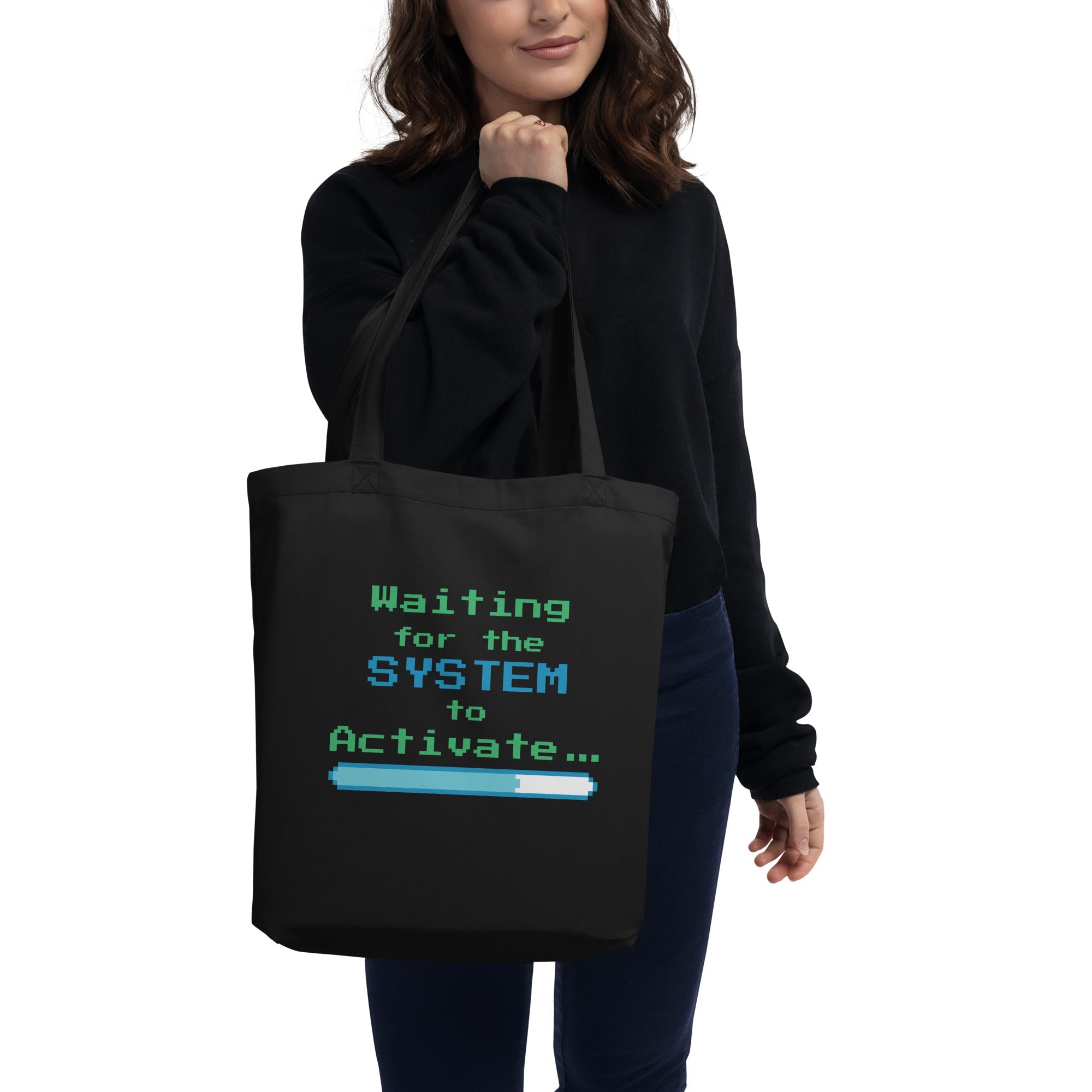 Person holding a black tote bag with text design on a white background