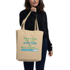 Person holding a beige tote bag with text design on a white background